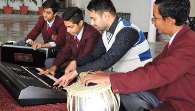 Students practicing keyboard and instrumental music in the school music room